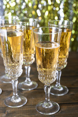 Glasses of champagne on bright background