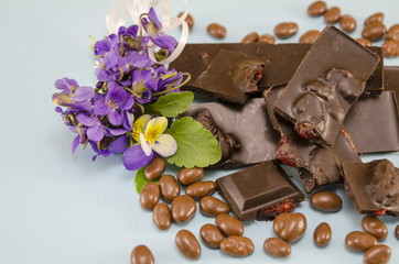 Dark chocolate with raisins, chocolate balls and a cup of coffee