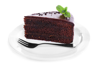 Piece of chocolate cake with mint isolated on white