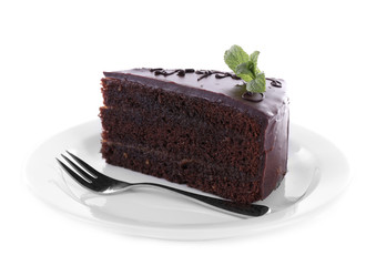 Piece of chocolate cake with mint isolated on white
