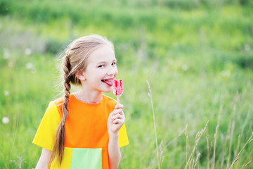 little girl eats ice-cream in the summer