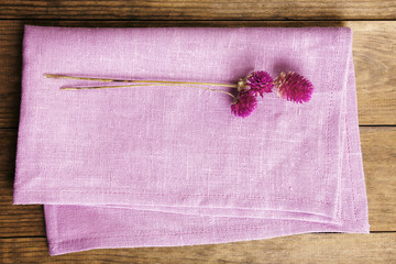 Beautiful dry flowers on napkin on wooden table close up