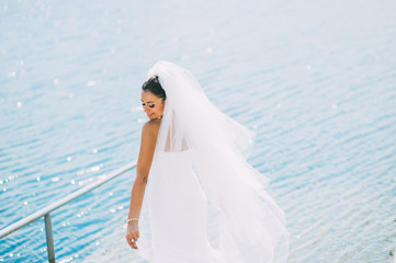 Fototapeta na wymiar Bride posing on the pier at the lake