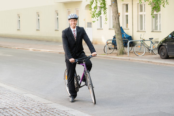Happy Man In Suit Riding Bicycle