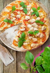 Rustic pizza topped with fresh basil leaves