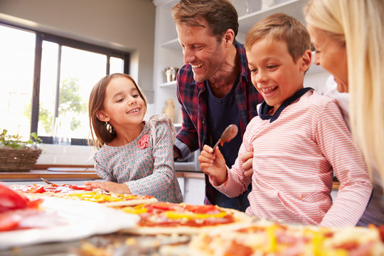 Family making pizza together