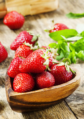 Fresh organic strawberries in a bowl in the shape of a heart, se