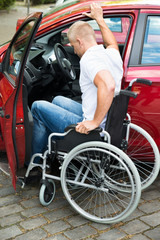 Obraz na płótnie Canvas Handicapped Man Boarding In His Car