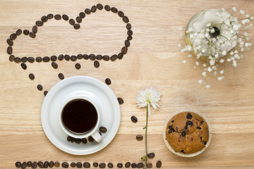 Obraz na płótnie Canvas Top view coffee,muffins,flower and coffee beans