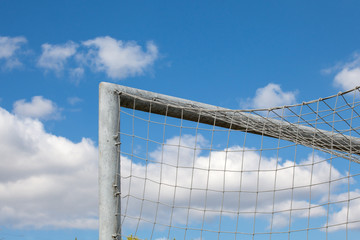 detail of football (soccer) goal ?nd a beautiful blue sky