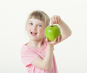 Fototapeta premium Happy little girl showing a green apple