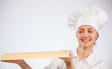 Smiling woman chef cook holding wooden board