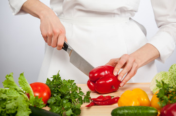 Cook's hands preparing vegetable salad - closeup shot