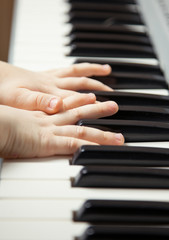 Fototapeta premium Child's hands playing the piano