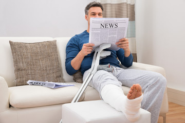 Disabled Man Reading Newspaper