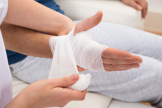 Nurse Bandaging Patient's Hand