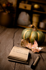 Open notebook on kitchen table with Autumn decorations