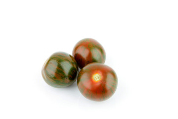 a fresh tomato with odd colors on a white background