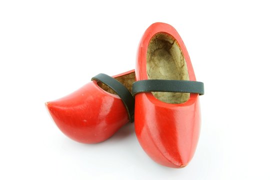 Red wooden shoes / Dutch clogs with a black leather strap. Traditional Dutch footwear for farmers.