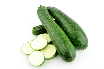 A stack of two zucchini / courgette with some slices (Cucurbita pepo)