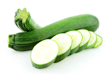 A stack of two zucchini / courgette with some slices (Cucurbita pepo)