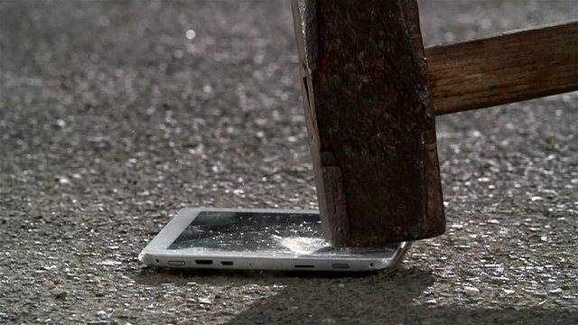 Hammer crash hitting a tablet pc computer, broken touch screen