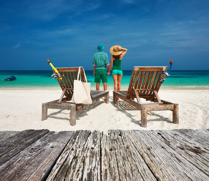Couple in green relax on a beach at Maldives