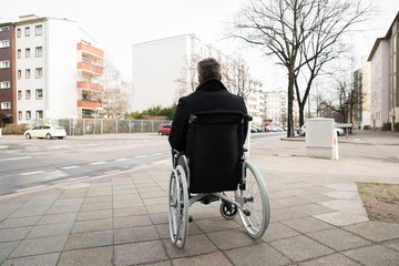 Disabled Man On Wheelchair Looking At Street