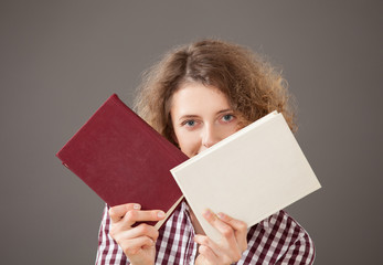 Portrait of a pretty young woman with a two books