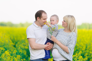 Mother, the father and the kid are on a rape field