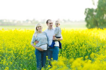 Mother, the father and the kid are on a rape field