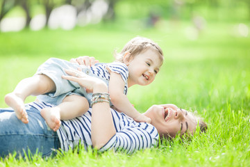 Portrait of a beautiful young woman with a small child in park