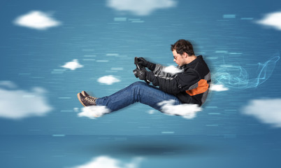 Funny racedriver young man driving between clouds concept