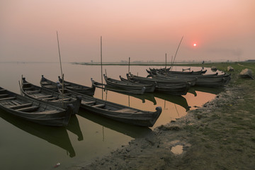 Fototapeta premium Wooden boats of fishermen at sunset, Amarapura, Myanmar