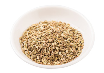 Cumin seed in white bowl over white background