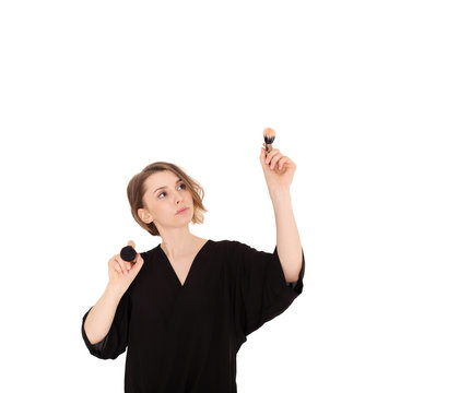 Beautiful woman makeup artist holding make up brushes for cosmetics on a white background isolated