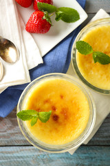 Creme brulee dessert  on napkin, on color wooden background