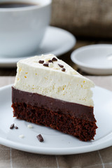 Vanilla cheesecake slice on wooden background.