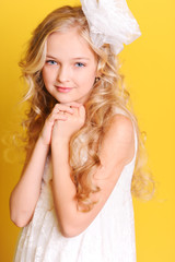 Smiling kid girl posing in studio