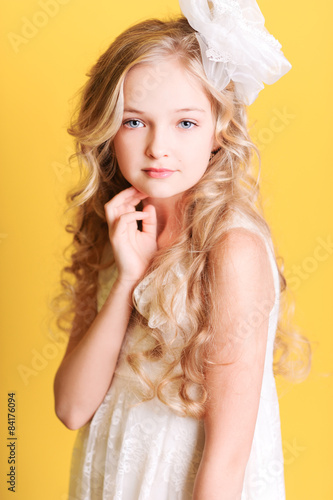 "Cute kid girl 10 years old posing over yellow background" Stock photo