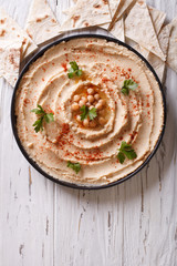 Classic hummus and pita bread. vertical top view
