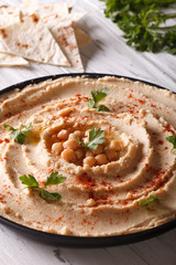 Vegetarian Hummu on the plate closeup. Vertical
