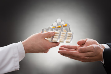 Doctor Giving Medicines To Patient