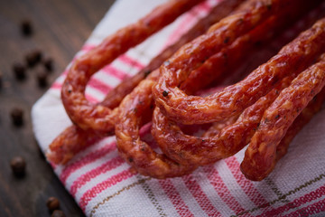 Sausage or kabanos and pepper on vintage wooden boards