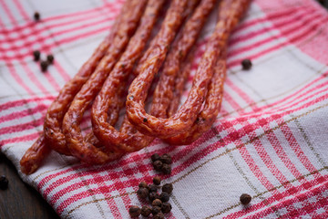 Sausage or kabanos and pepper on vintage wooden boards