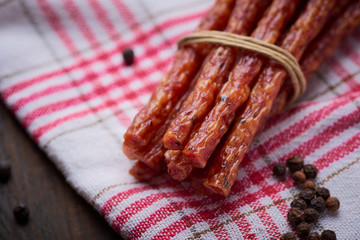 Sausage or kabanos and pepper on vintage wooden boards