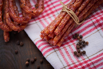 Sausage or kabanos and pepper on vintage wooden boards