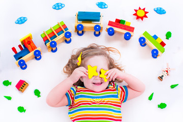 Little girl with wooden train