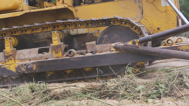 Unidentified worker control Bulldozer to excavator grader removing the ground