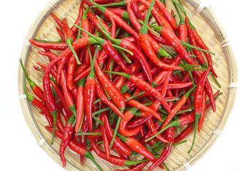  Pile of fresh red chili in bamboo tray on white background.